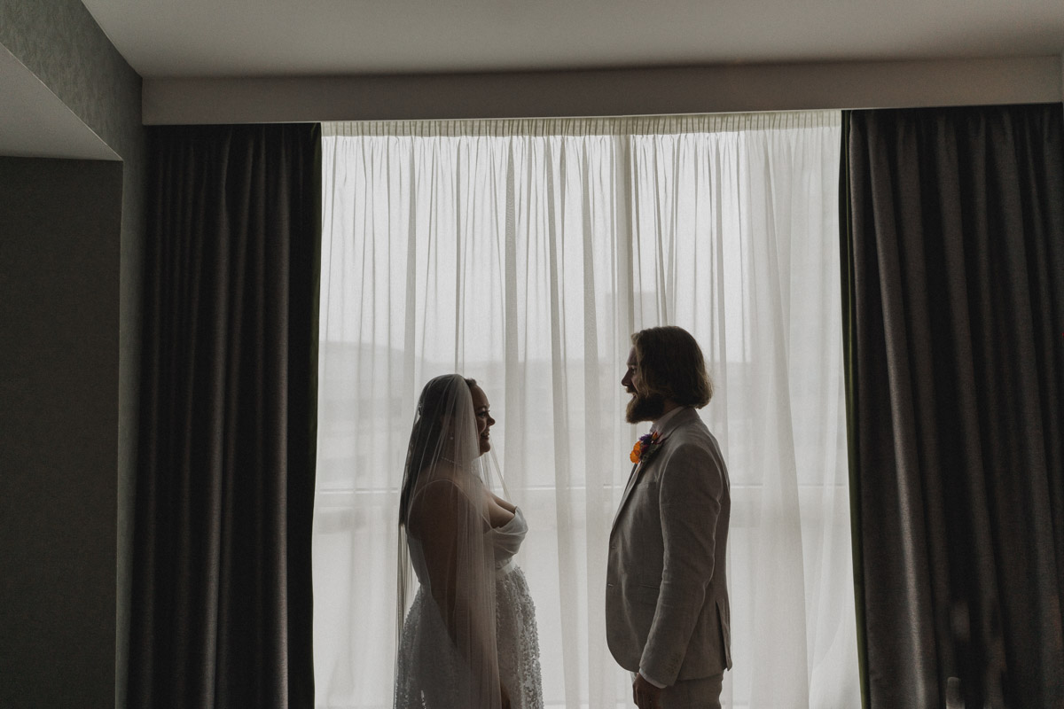 Morning wedding preparations, bride and groom windo silhouette