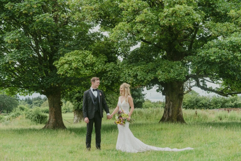 Bride and groom portrait in a field