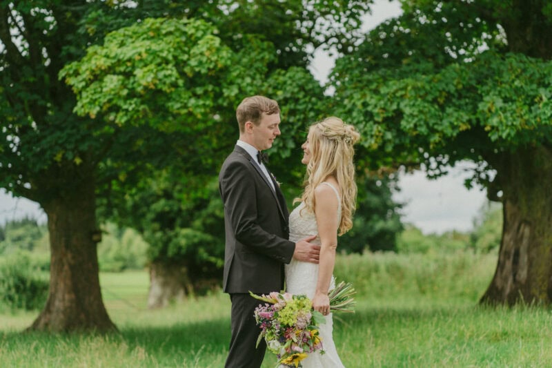 Bride and groom portrait in a field