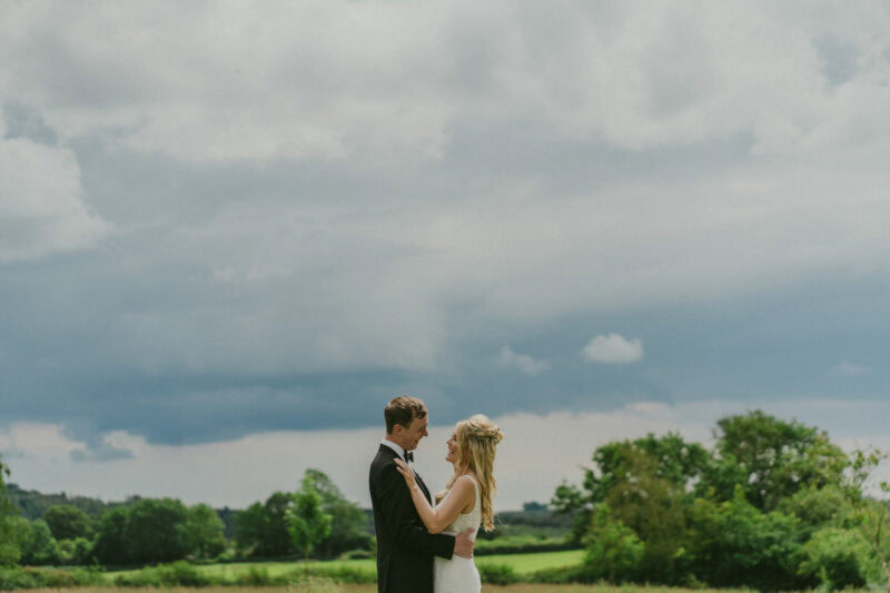 Bride and groom portrait in a field
