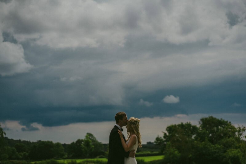 Bride and groom portrait in a field