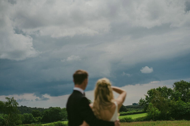 Bride and groom portrait in a field out of focus
