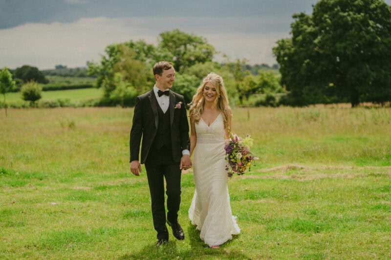 Bride and groom portrait in a field