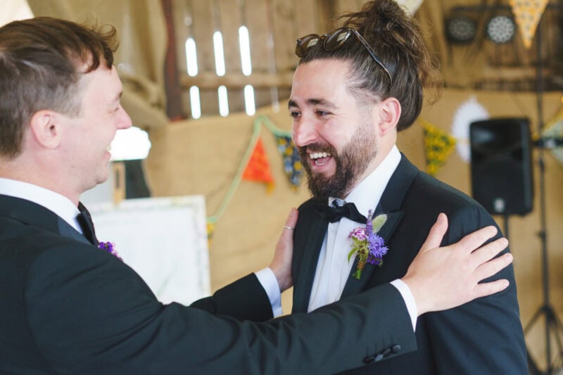 Groom and best man lauging