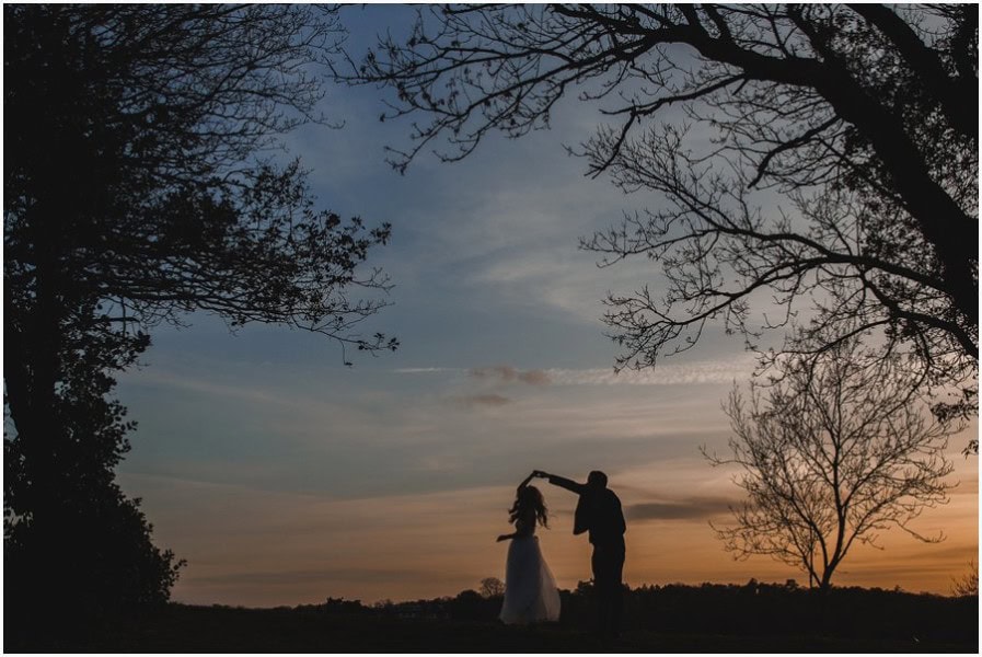 Bride and groom sunset silhouette dancing